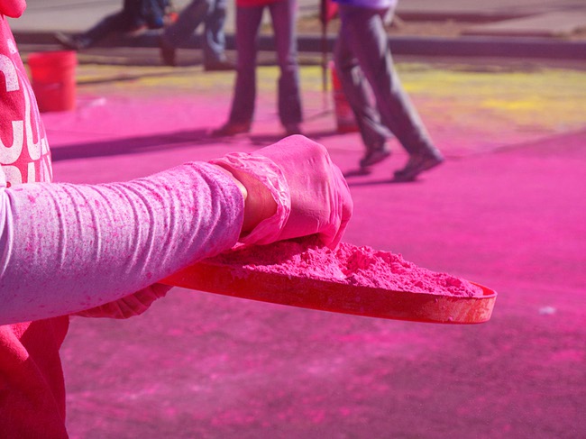 A volunteer prepares to dust runners during first Color Run in downtown Las Vegas, Saturday, Feb. 25, 2012. Runners get dusted with a different color at each kilometer checkpont. About 5,000 participants ran a 5K event which benefits the Three Square charity.