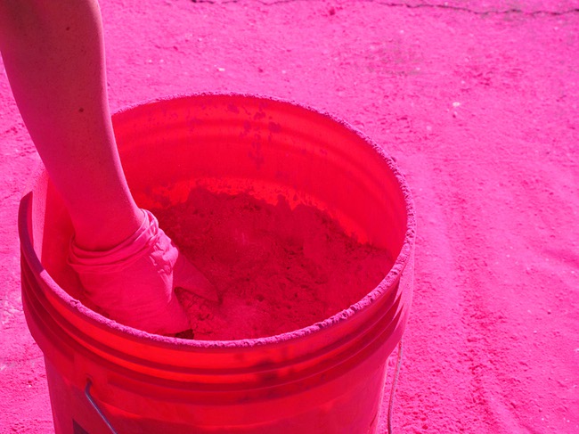 A volunteer prepares to dust runners during first Color Run in downtown Las Vegas, Saturday, Feb. 25, 2012. Runners get dusted with a different color at each kilometer checkpont. About 5,000 participants ran a 5K event which benefits the Three Square charity.