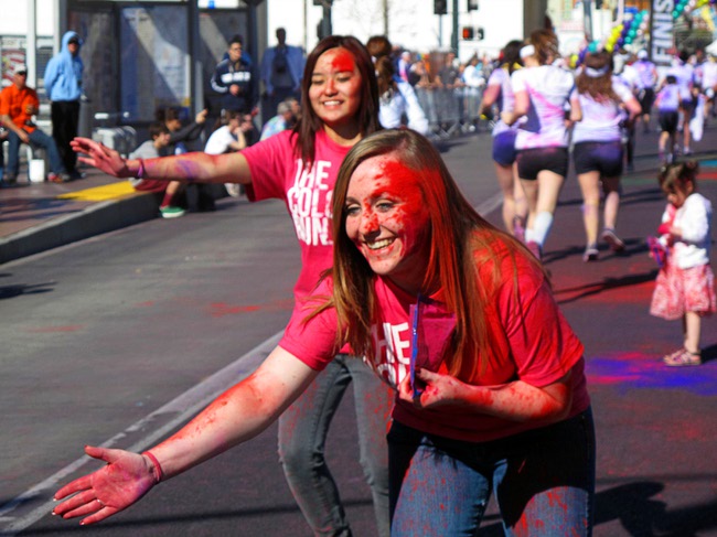 Women cheer on runners near the finish line during first Color Run in downtown Las Vegas, Saturday, Feb. 25, 2012. About 5,000 participants ran a 5K event which benefits the Three Square charity.