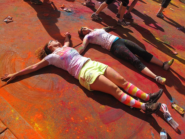 Runners make dust angels after the first Color Run in downtown Las Vegas, Saturday, Feb. 25, 2012. About 5,000 participants ran a 5K event which benefits the Three Square charity.