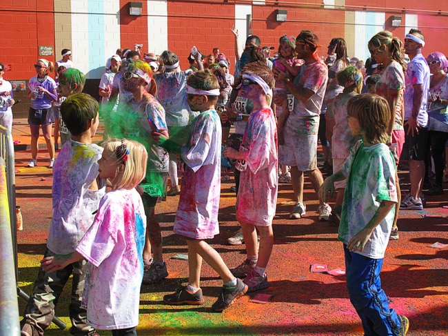 Children play with bags of colored dust during first Color Run in downtown Las Vegas, Saturday, Feb. 25, 2012. About 5,000 participants ran a 5K event which benefits the Three Square charity.
