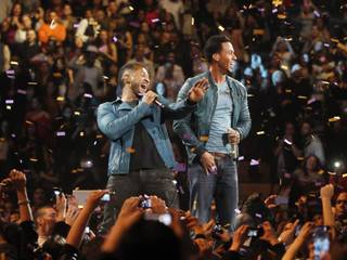 Romeo Santos, right, performs with Usher during a concert at Madison Square Garden, Friday, Feb. 24, 2012 in New York.