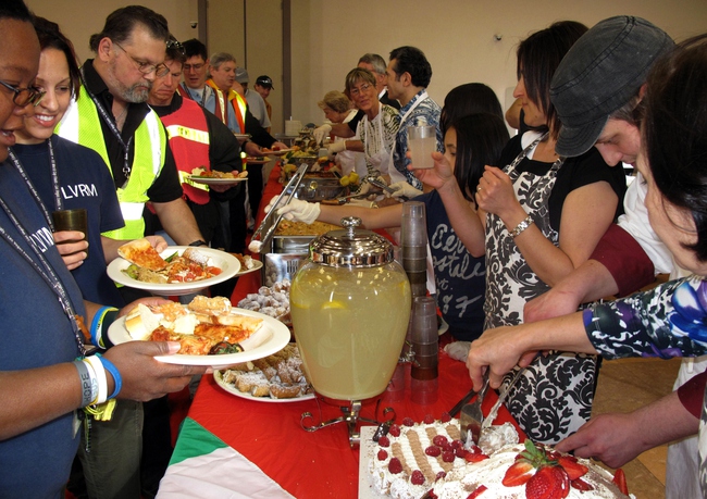 Volunteers serve residents of the Las Vegas Rescue Mission and the homeless for their monthly "Dinner On Us" event. The March theme was Italian food.