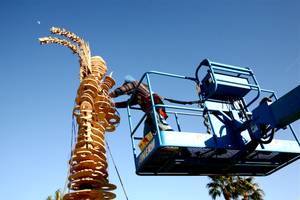 Workers and performers prepare for the burn of "Lucky Lady Lucy" in downtown Las Vegas on Friday, March 2, 2012. 