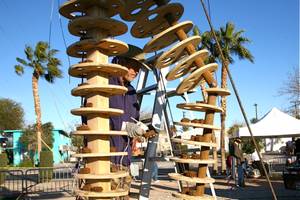 Workers and performers prepare for the burn of "Lucky Lady Lucy" in downtown Las Vegas on Friday, March 2, 2012. 