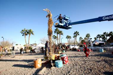 Workers and performers prepare for the burn of “Lucky Lady Lucy” in downtown Las Vegas on Friday, March 2, 2012. 