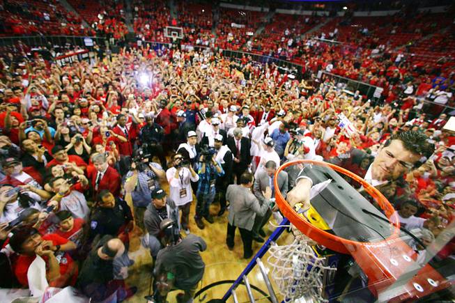 New Mexico head coach Steve Alford cuts down the net after the Lobos defeated San Diego State in the Mountain West Conference tournament championship game 68-59 Saturday, March 10, 2012 at the Thomas & Mack Center.