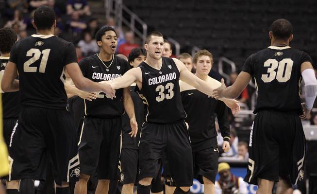 Colorado's Andre Roberson, left, and Colorado's Carlon Brown, right, are greeted by teammates during the second half of an NCAA college basketball game against the Oregon at the Pac-12 conference championship in Los Angeles, Thursday, March 8, 2012.