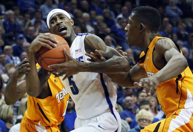 Memphis guard Will Barton (5) gets tangled with Tennessee guard Josh Richardson, right, in the second half of an NCAA college basketball game on Wednesday, Jan. 4, 2012, in Memphis, Tenn. Memphis won 69-51.