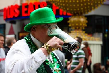 Lance Fitzgerald, of Colorado, sips a green beer stuck in his beer mug while celebrating St. Patrick’s Day at Hennessey’s Tavern Block Party Saturday, March 17, 2012, in Las Vegas.