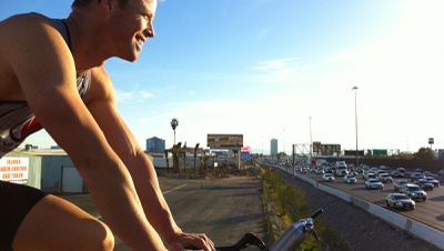 Stationary bicyclist rides daily alongside I-15; destination is fitness for all