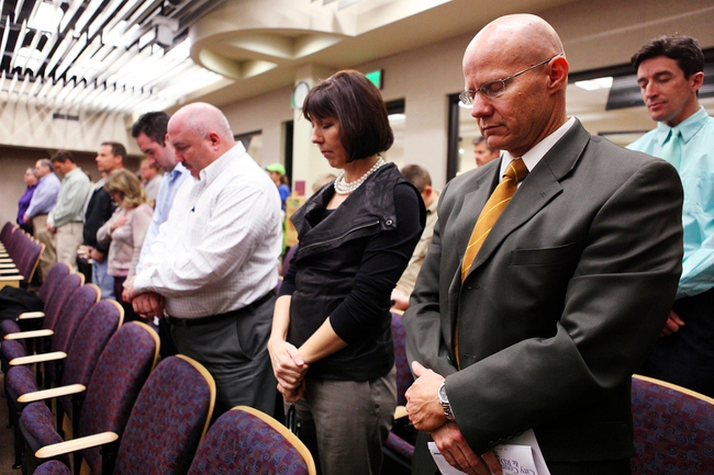 Jacob Snow, whose contract was approved to become the new Henderson city manager during the Henderson City Council meeting, bows his head during invocation before the meeting at City Hall in downtown Henderson on Tuesday, March 20, 2012.