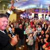 Shane Stephens, a casino host at Boulder Station, riles up the crowd before announcing the winning numbers in a drawing at the casino in Las Vegas on Friday, March 23, 2012.
