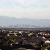The Las Vegas skyline, including hotels and casinos from the world-famous Strip, looms in the background of row upon row of houses.