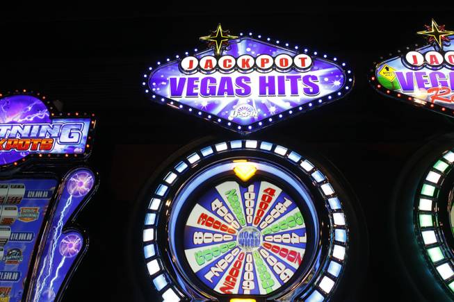 A Vegas Hits slot machine by Bally Technologies is displayed in the company's showroom Thursday, March 29, 2012.