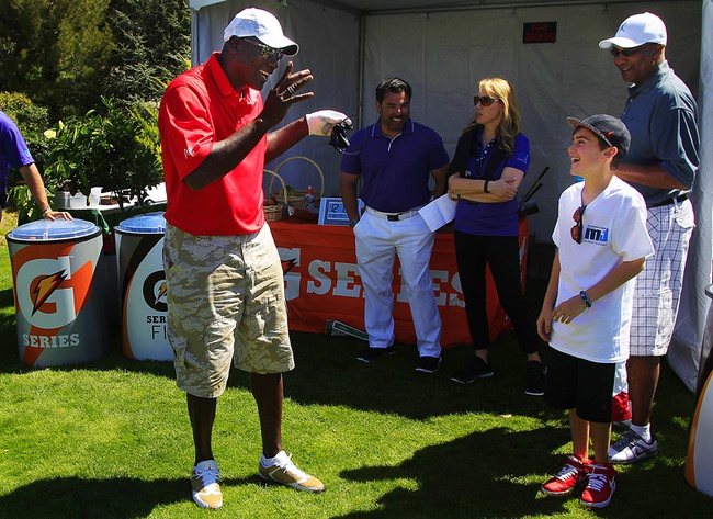 Michael Jordan jokes with Noah Portnoy during Friday's round at the Michael Jordan Invitational March 30, 2012 at Shadow Creek.