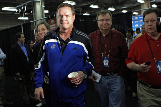 Kansas head coach Bill Self is followed by reporters after a news conference in New Orleans, Thursday, March 29, 2012. Kansas is scheduled to play Ohio State in an NCAA tournament Final Four semifinal college basketball game on Saturday.