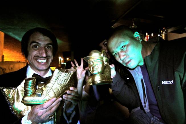 The Gazillionaire presents golden alligator shoes to Tony Hsieh.