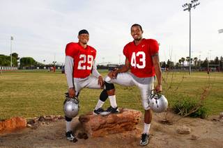 Brothers Tajh Hasson, left, 19, and Tim Hasson, 20, pose after practice at UNLV's Rebel Field Monday, April 16, 2012. Tajh plays strong safety, Tim is an outside linebacker.