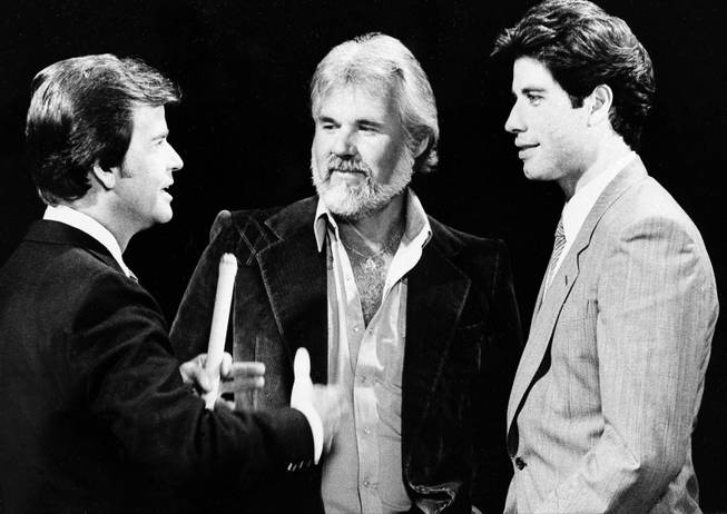 “American Bandstand” host Dick Clark reminisces with Kenny Rogers and John Travolta about their early music careers during the taping of “American Bandstand’s 30th Anniversary Special” on Oct. 27, 1981.