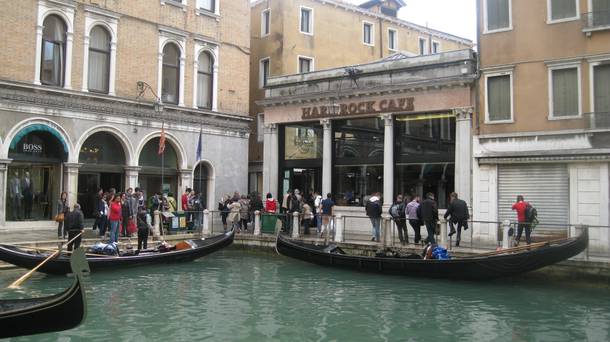 Gondola's push off in the shadows of the Hard Rock Cafe in Venice.
