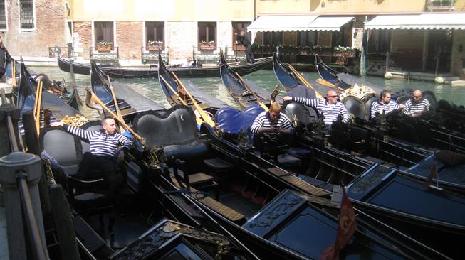 Gondoliers, awaiting passengers. These are the rock stars of Venice.