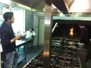With Mateo Berucci enjoying a nice Chianti and an employe stoking a fire, Frankie Moreno sings in the kitchen of Bellavista Ristorante in Impruneta, Italy.
