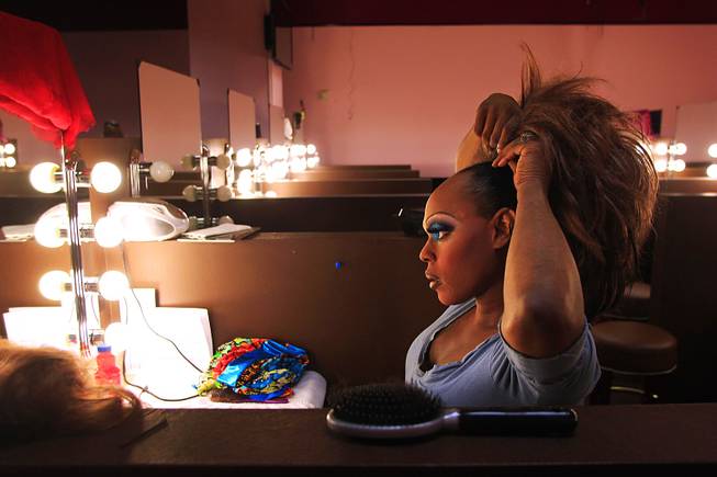 Desarae Pendavis fixes her wig before work at Drink & Drag, a new bar at Neonopolis featuring bowling and drag queens Thursday, April 26, 2012.