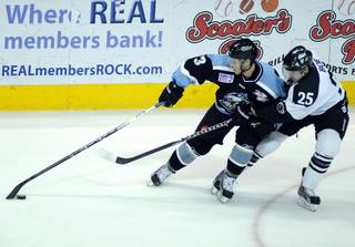 Alaska winger Scott Howes keeps the puck away from Wranglers defenseman Channing Boe during the first period of game one of the ECHL Western Conference Finals at the Orleans Arena on Thursday night.