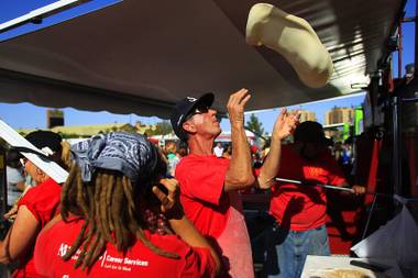 Bill Wise tosses pizza dough while making pizza in the wood fired oven of a converted fire engine at the 2012 Las Vegas Foodie Fest Saturday, April 28, 2012 in the parking lot of the Silverton.