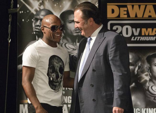 Richard Schaefer, right, CEO of Golden Boy Promotions, talks with Floyd Mayweather Jr. during a news conference at the MGM Grand May 2, 2012. Golden Boy is promoting a fight between WBC super welterweight champion Canelo Alvarez of Mexico and Victor Ortiz at the MGM Grand Garden Arena on September 15. On the same day, Julio Cesar Chavez Jr., promoted by Top Rank, will defend his WBC middleweight title against Sergio Gabriel Martinez at the Thomas & Mack Center.