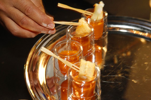 Chef Michael Mina places pieces of lobster grilled cheese sandwich over tomato bisque during the Vegas Uncork'd "Follow That Truck" food festival at the Bellagio Thursday May 20, 2012. Celebrity chefs added to the gourmet fare from more than a dozen food trucks for the festival outside under the lights at Bellagios Hidden Drive.