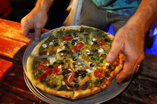 Keith Hicks displays a Pesto-Veggie pizza, with basil and goat cheese, at the Engine 1 Pizza food truck during the Vegas Uncork'd "Follow That Truck" food festival at the Bellagio Thursday May 20, 2012. Celebrity chefs added to the gourmet fare from more than a dozen food trucks for the festival outside under the lights at Bellagios Hidden Drive.