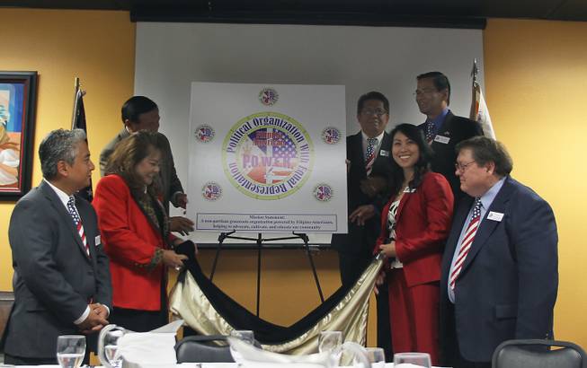 The board of directors and staff of the newly formed Filipino-American Political Organization With Equal Representation unveil the organization's logo at a luncheon Friday. The members (clockwise from left) are Cesare Almase, legal counsel, Amie Belmonte, president, Cesar Elpidio, board member, Leo Belmonte, board member, Bernie Benito, board member, Cynthia Deriquito, board member, secretary and treasurer, and Luke Perry, director of communications and government affairs. The non-partisan organization is dedicated to advancing political awareness and participation among the Filipino-American community.  