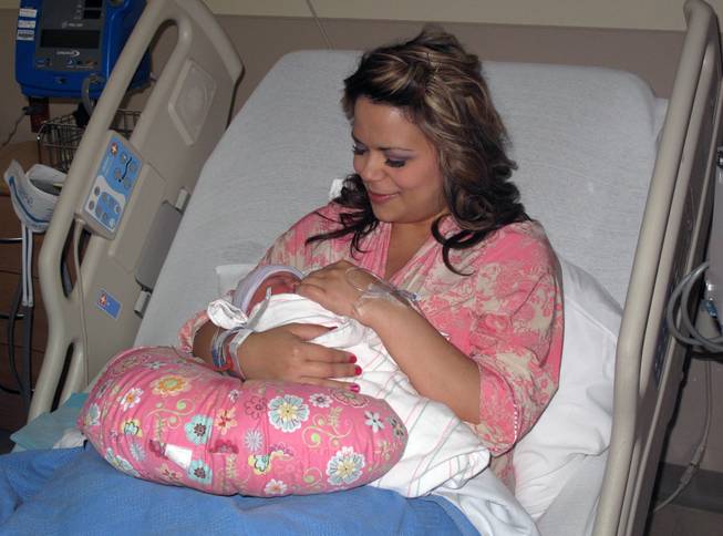 Mary Wernert cradles her infant daughter Madeline Isabella, who was born at 2:21 a.m. Sunday at Sunrise Children's Hospital. The Wernert family received a basket of safety items from SAFE KIDS Clark County in honor of Mother's Day.