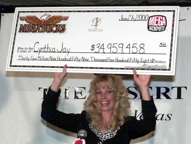 Cynthia Jay holds up an oversized check at the Desert Inn Thursday, January 27, 2000. Jay won a record Megabucks jackpot for $34,959,458.56 on Wednesday at the hotel-casino. It is the world's largest jackpot ever hit on a slot machine. Jay invested $27 before hitting the jackpot on her last spin.