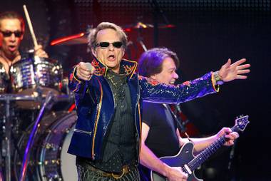 Van Halen frontman David Lee Roth performs at the MGM Grand Garden Arena Sunday, May 27, 2012. In the background are Alex Van Halen, left, on drums, and guitarist Eddie Van Halen.