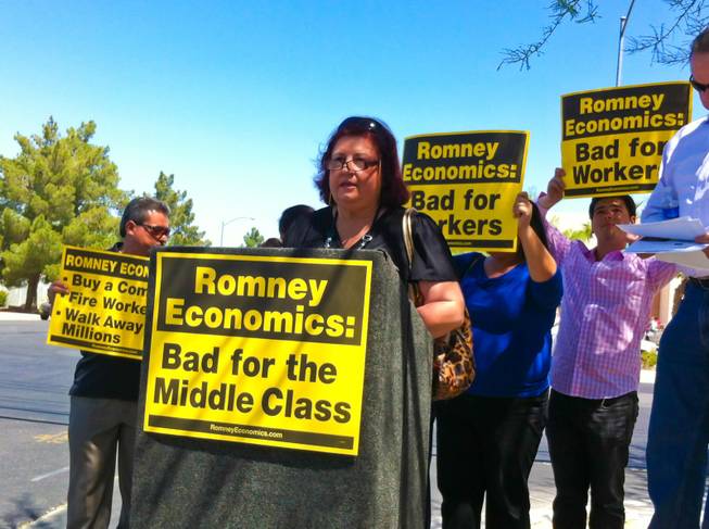 Reyna Bernal, an Obama supporter and local small business owner, voices her concerns against Romney campaign outside an event where the presidential hopeful is scheduled to speak, Tuesday May 29, 2012.