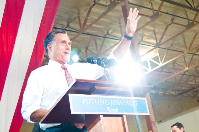 Presidential hopeful Mitt Romney addresses supporters during a campaign rally ...
