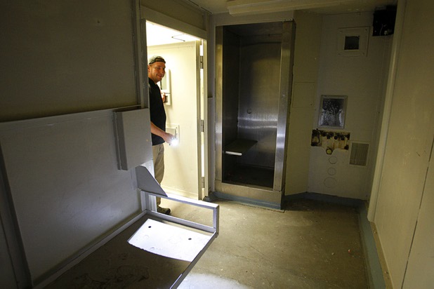 Tom Svetz, an assistant project superintendent for the Penta Building Group, shines a flashlight in a City of Las Vegas jail cell in the old Las Vegas City Hall Friday, June 1, 2012.