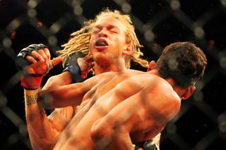 Charles Oliveira hits Jonathan Brookins during their bout at The Ultimate Fighter 15 Friday, June 1 2012.