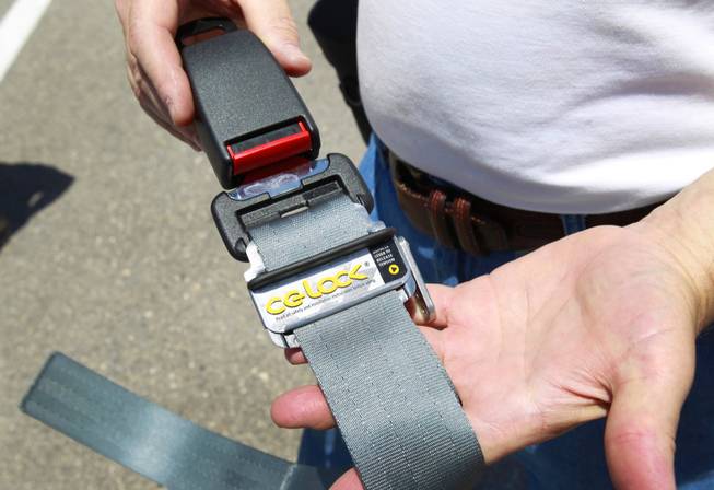Bruce Mather displays his CG-Lock during car crash testing at the Las Vegas Motor Speedway Monday, June 4, 2012. The invention allows the driver to tighten the lap belt without affecting movement in the shoulder belt. The CG-Lock was originally designed for sports car drivers but seems to have significant safety advantages for normal drivers in a crash, Mather said.