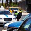 Taxicab Authority Police stop taxis at a long haul checkpoint near the entrance to the airport tunnel exiting McCarran International Airport in Las Vegas on Friday, June 8, 2012.