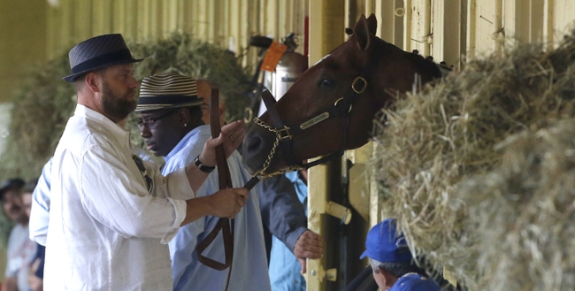 Doug O'Neill, foreground, trainer of Kentucky Derby and Preakness winner I'll Have Another, brings the horse out for a news conference at Belmont Park in Elmont, N.Y., on Friday, June 8, 2012. I'll Have Another's bid for a Triple Crown ended with the shocking news that the colt was out of the Belmont Stakes due to a swollen left front tendon. 