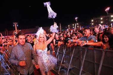 Electric Daisy Carnival founder Pasquale Rotella and reality TV and “Peepshow” star Holly Madison make their way through the crowd during the first night of the Electric Daisy Carnival early Saturday, June 9, 2012, at Las Vegas Motor Speedway.