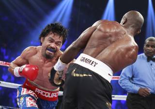 Manny Pacquiao punches at Timothy Bradley Jr. during their WBO welterweight title fight at MGM Grand Garden Arena on Saturday, June 9, 2012. Bradley won a controversial split decision.