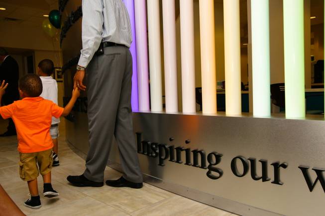Two-year-old Miles Russell II takes a tour of the Martin Luther King Health Center with his dad, Miles Russell, during its opening Monday, June 11, 2012, in Las Vegas. The Affordable Care Act included $728 million in grants for community health centers like the Martin Luther King Health Center, which expects to treat 11,000 patients annually.