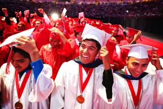 Advanced honors students Freddy Santiago, from left, Liborio Chicas and Kevin Omar Alfaro Martinez move their tassles during the Western High School commencement ceremony at the Orleans Arena on Wednesday, June 20, 2012.