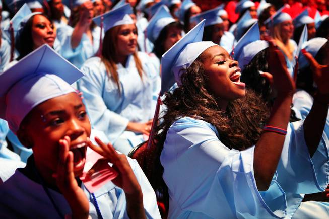 Dakia Johnson, left, and Tiara de la Cruz Johnson, right, cheer during the Western High School commencement ceremony at the Orleans Arena on Wednesday, June 20, 2012.