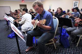 Forrest Jones plays a vihuela during a mariachi workshop for music teachers from around the country Wednesday, June 27, 2012.